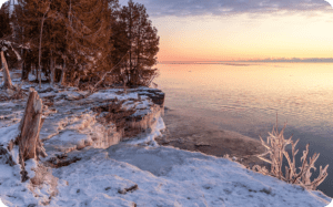 A winter sunrise over Lake Michigan, looking out from Cave Point