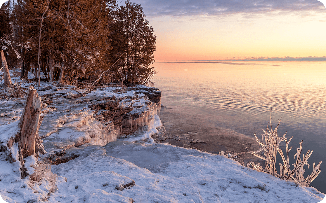 A winter sunrise over Lake Michigan, looking out from Cave Point