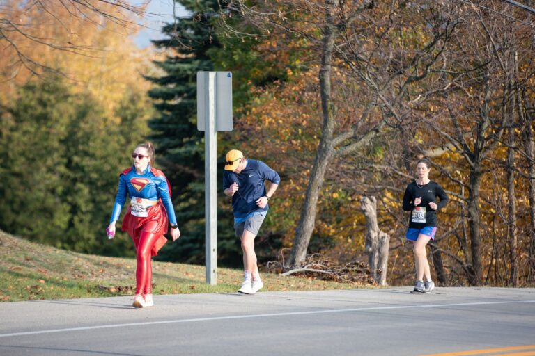 Costumed Fall 50 runner climbing the Ellison Bay hill