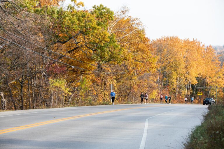 Runners climbing Highway 42 out of Ellison Bay during the Fall 50