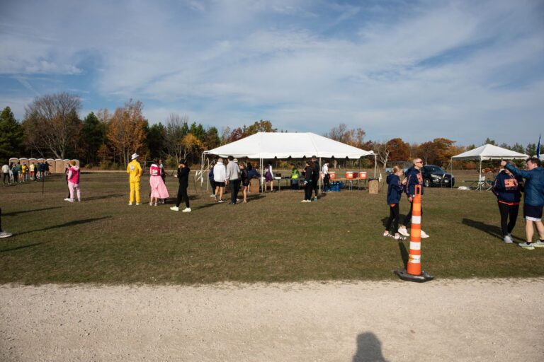 Costumed runners and team tents at Fall 50 Exchange 1