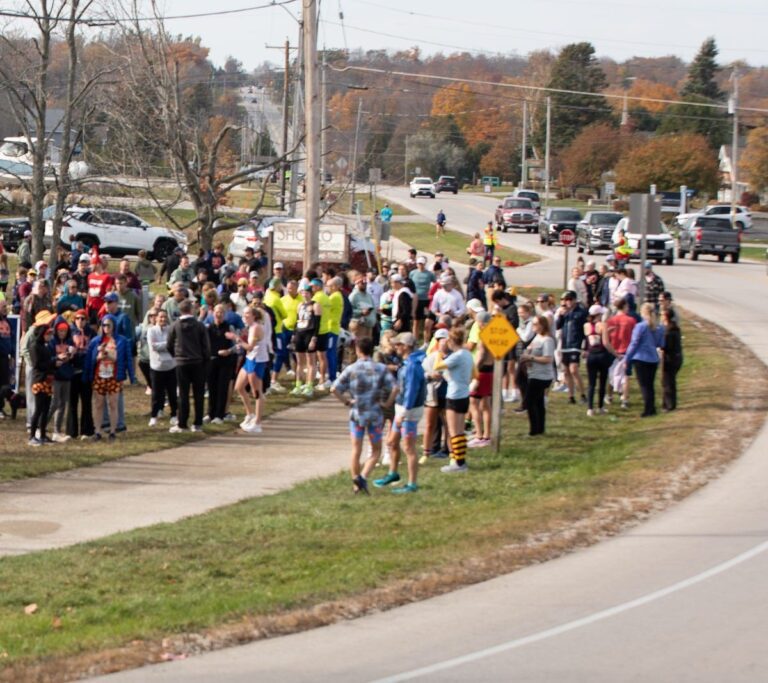Crowd of relay runners waiting at Fall 50 Exchange 2 in Sister Bay