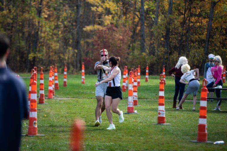 Relay hand-off at Fall 50 Exchange 3 at Nicolet Bay Beach