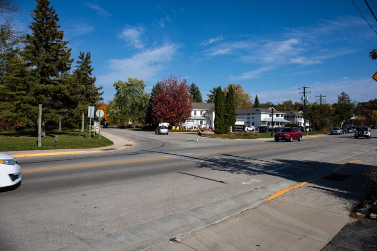 Fall 50 runner crossing Main Street in Fish Creek