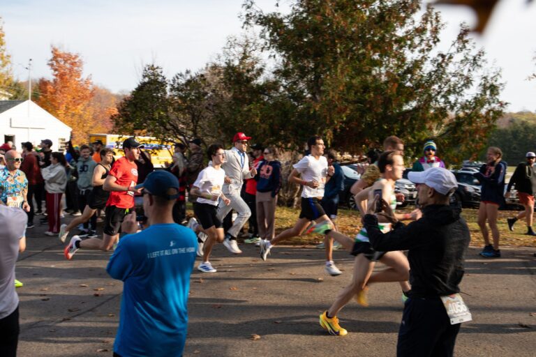 Relay runners sprinting away from the Fall 50 start in Gills Rock