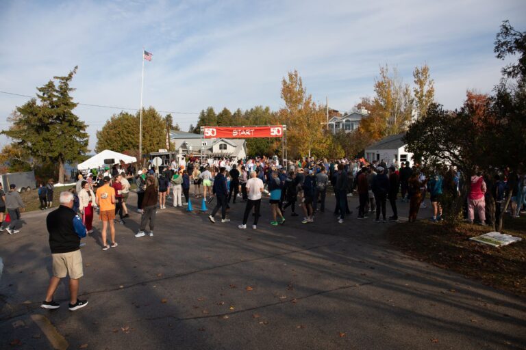 Crowd of runners and spectators at the Fall 50 start area