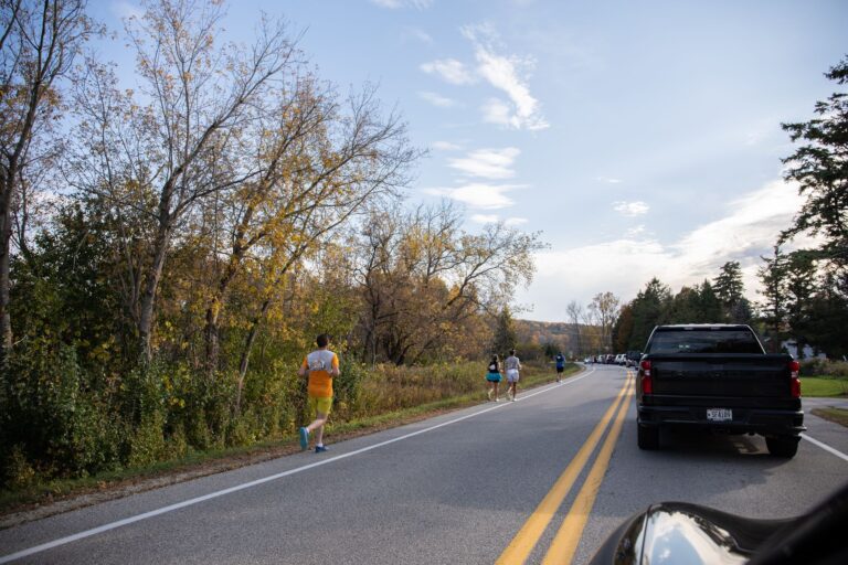 Fall 50 runner and support vehicle on Bay Shore Drive