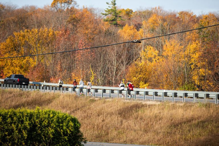 Fall 50 runners climbing Little Sister Hill near Sister Bay