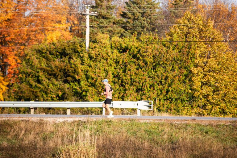 Runner climbing Little Sister Hill during the Fall 50