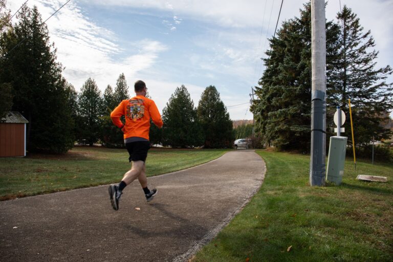 Fall 50 runner passing Open Hearth Lodge in Sister Bay