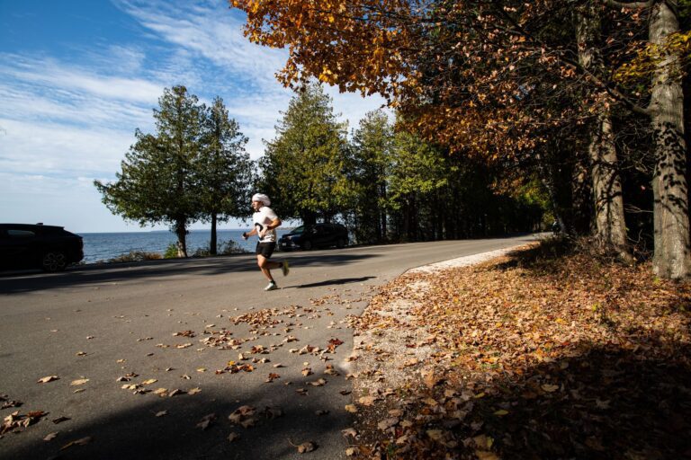 Runner on the Fall 50 Leg 4 shoreline route in Peninsula State Park
