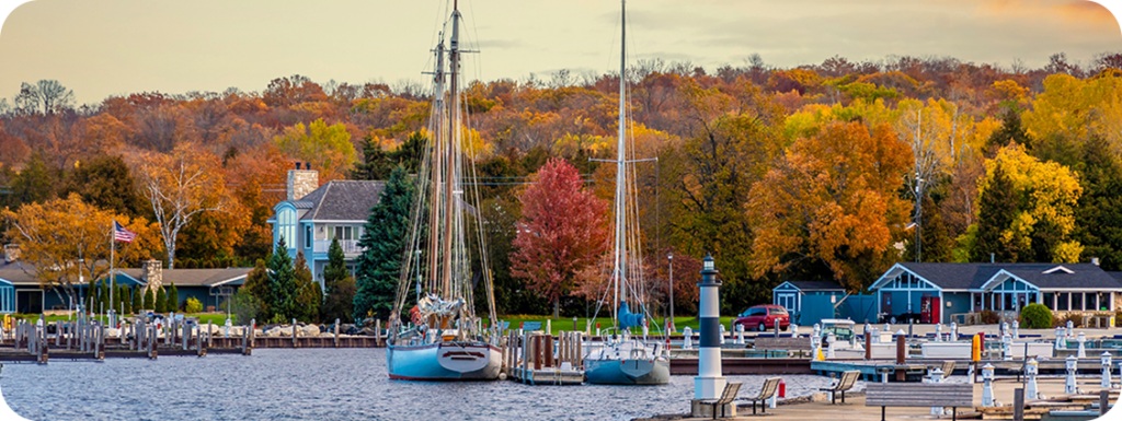 Sailboats in a harbor with fall colors