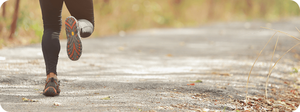 A runner on a gravel trail